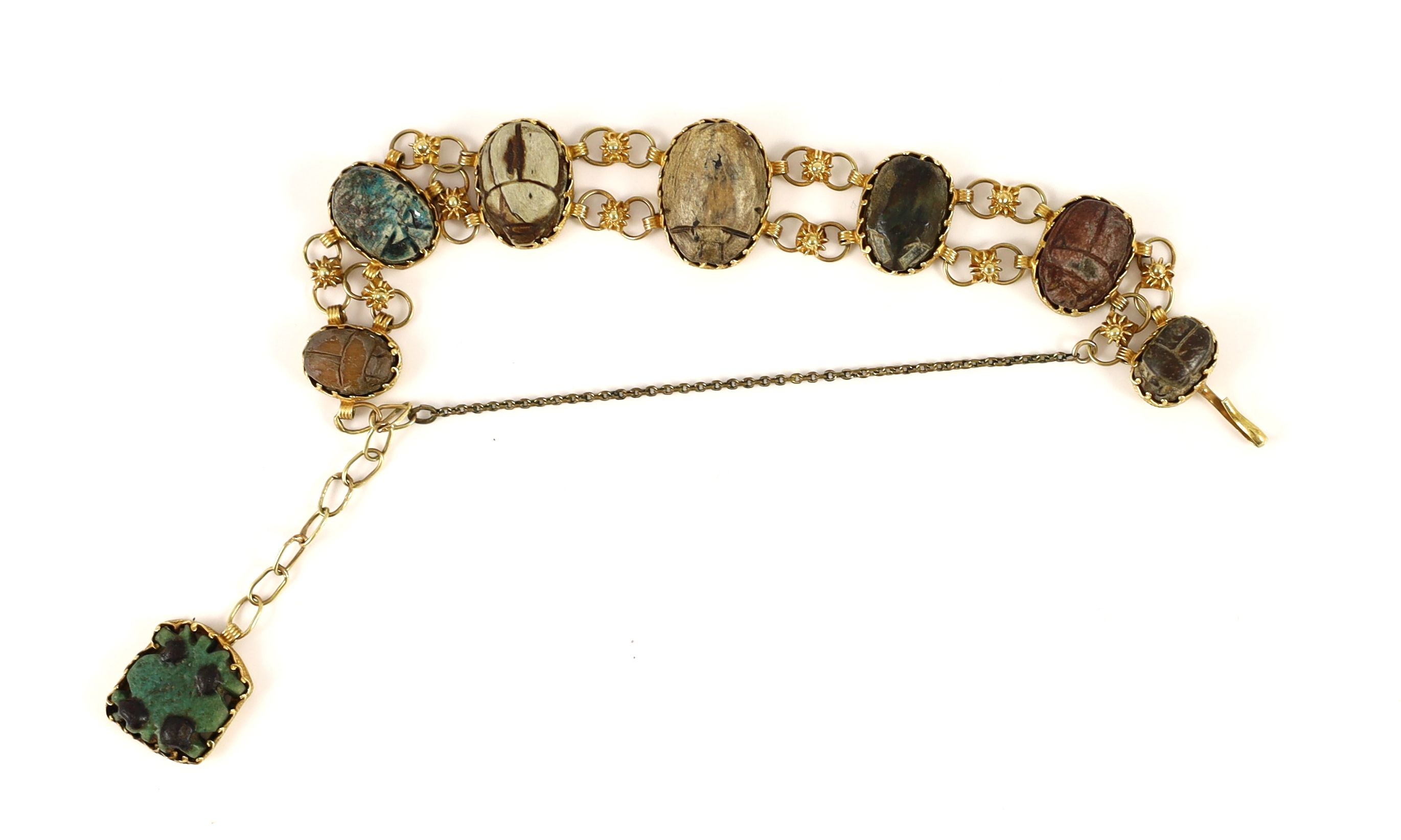 A 19th century gold and graduated seven antique stone scarab set bracelet